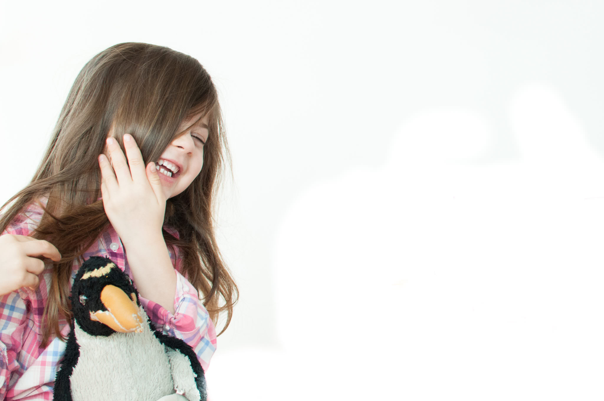 Girl laughing with a penguin, Northville Child Photography