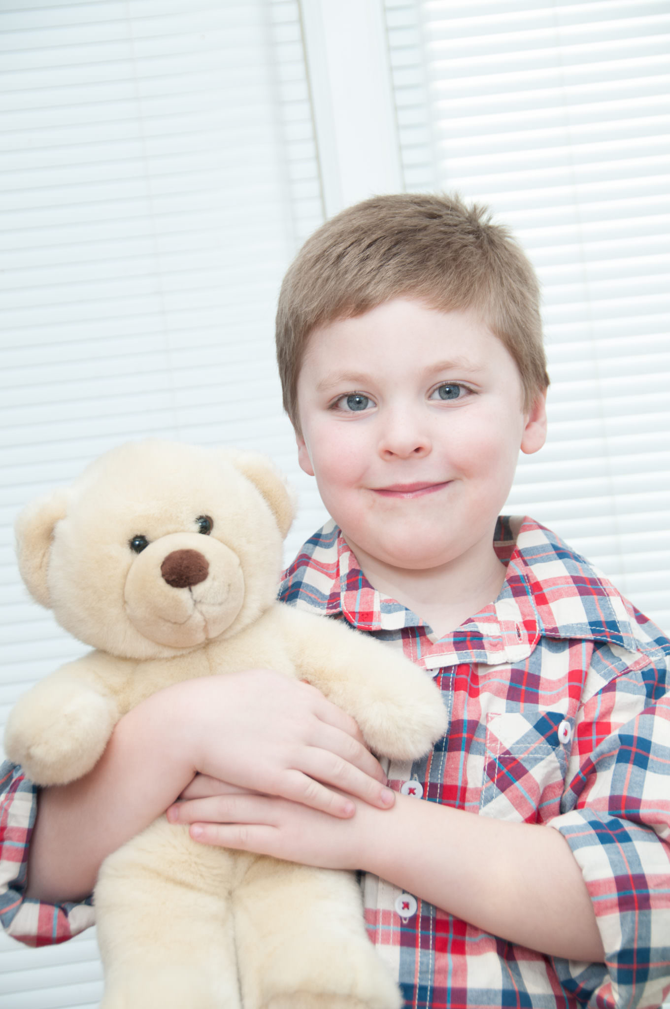 Older boy holding a teddy bear, South Lyon Child Photographer