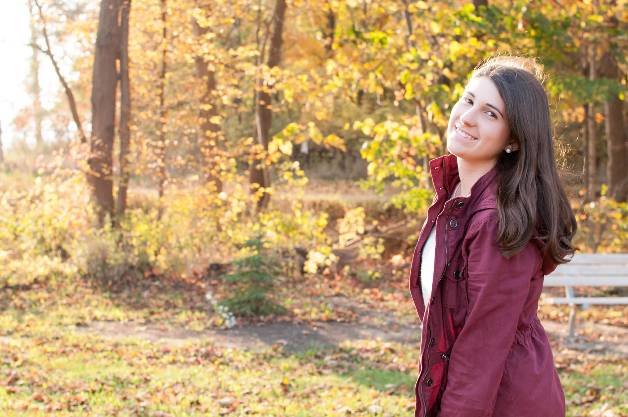 Girl in the fall looking sideways at the camera, Plymouth MI Senior Portraits