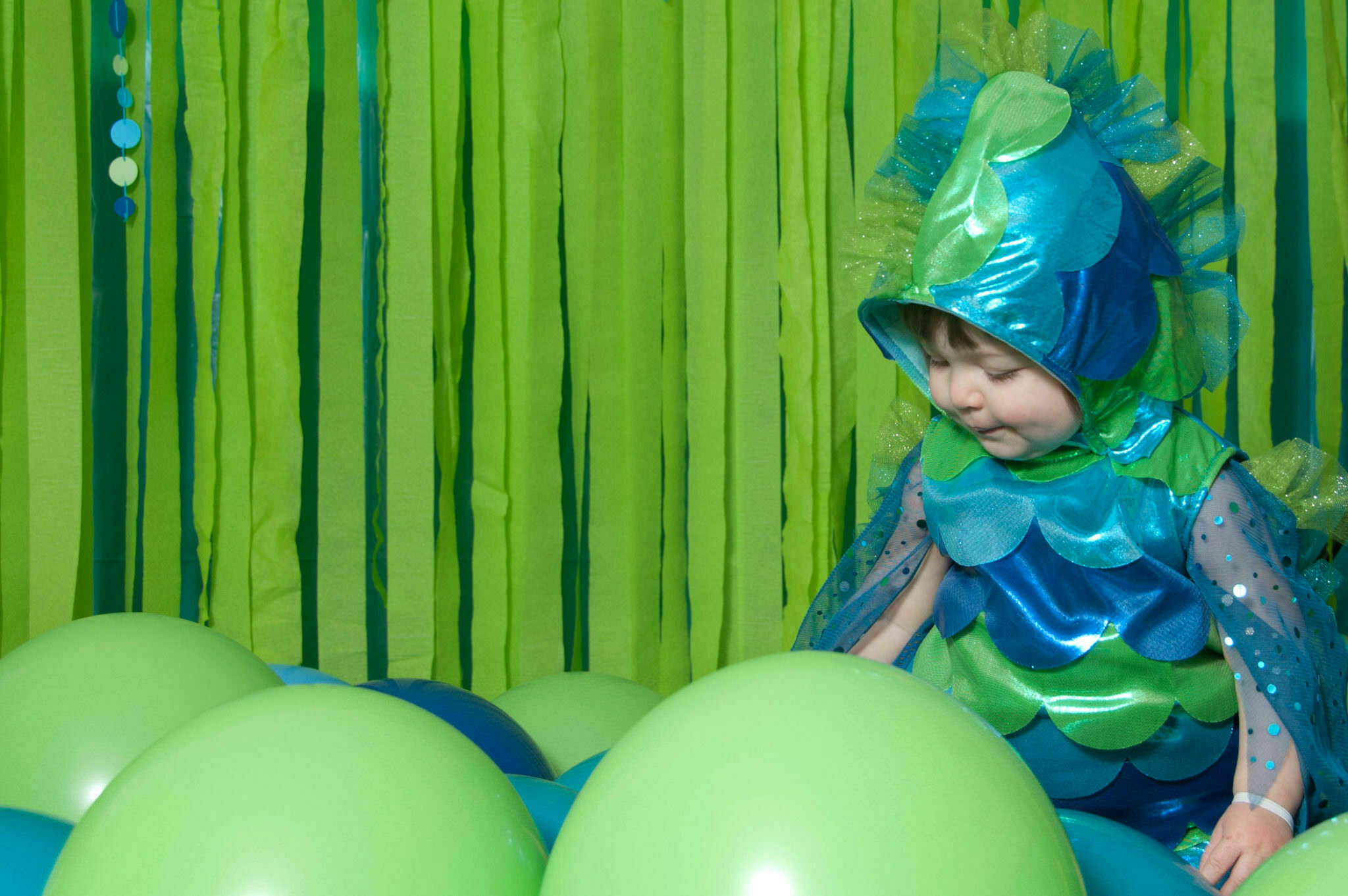 Baby playing in green balloons, Northville Child Portrait Photographer
