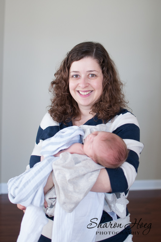 Mom smiling with new baby, South Lyon Newborn Portrait Photography