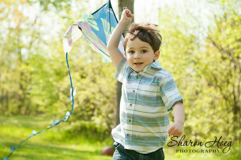 young boy running with a kite over his head, Northville Child Photographer