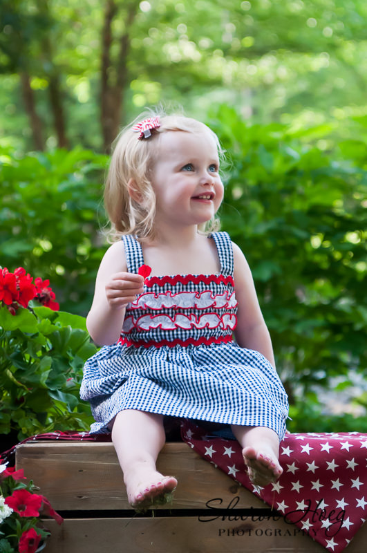 young patriotic girl smiling off-camera, South Lyon Child Photographer