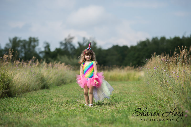 young girl dressed as a rainbow unicorn, Northville Child Photography